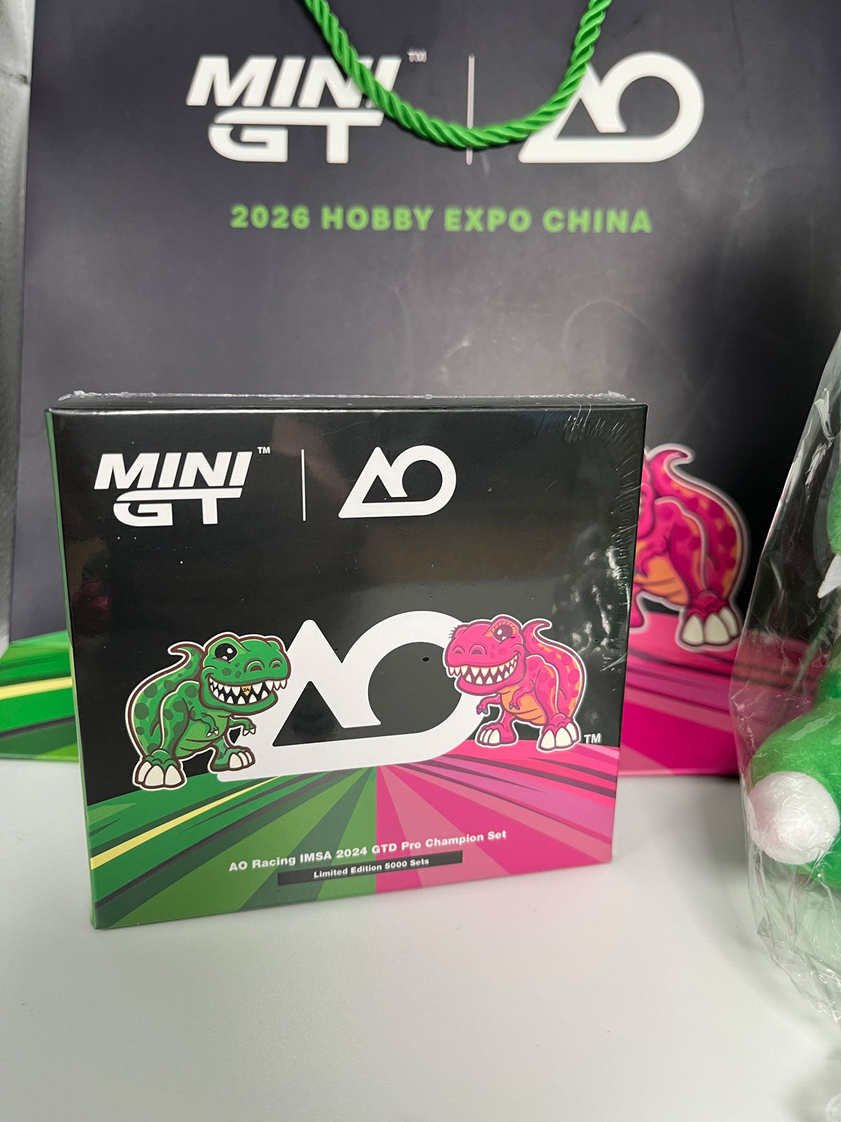 Mini GT HEC EXCLUSIVE #1198 & #1199 - AO Racing IMSA 2024 GTD Pro Champion Set inkl. Tüte und Plushie | 1:64